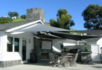shades of blue shade sails white colour building and sails