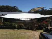 shades of blue shade sails building with garden and sails