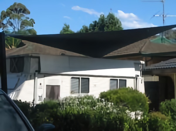 shades of blue shade sails white colour house and beautiful sky